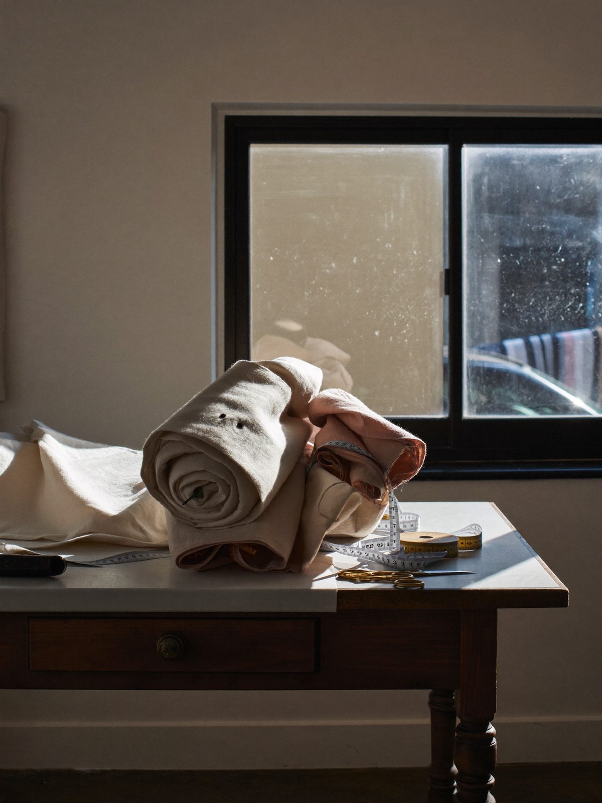 Sunlit atelier with bolts of natural linen